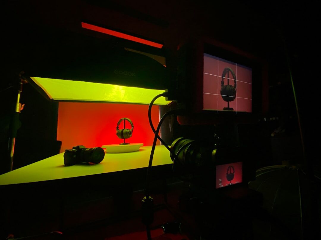 Studio lighting rig with colored gels glowing above a television set