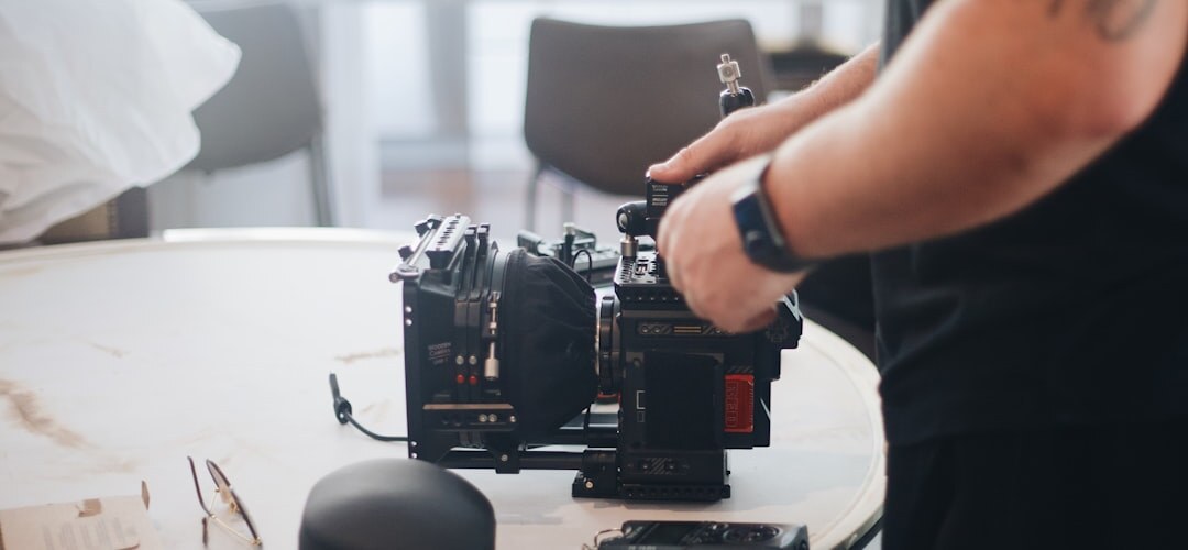 Close up of camera operator hands adjusting a broadcast camera rig