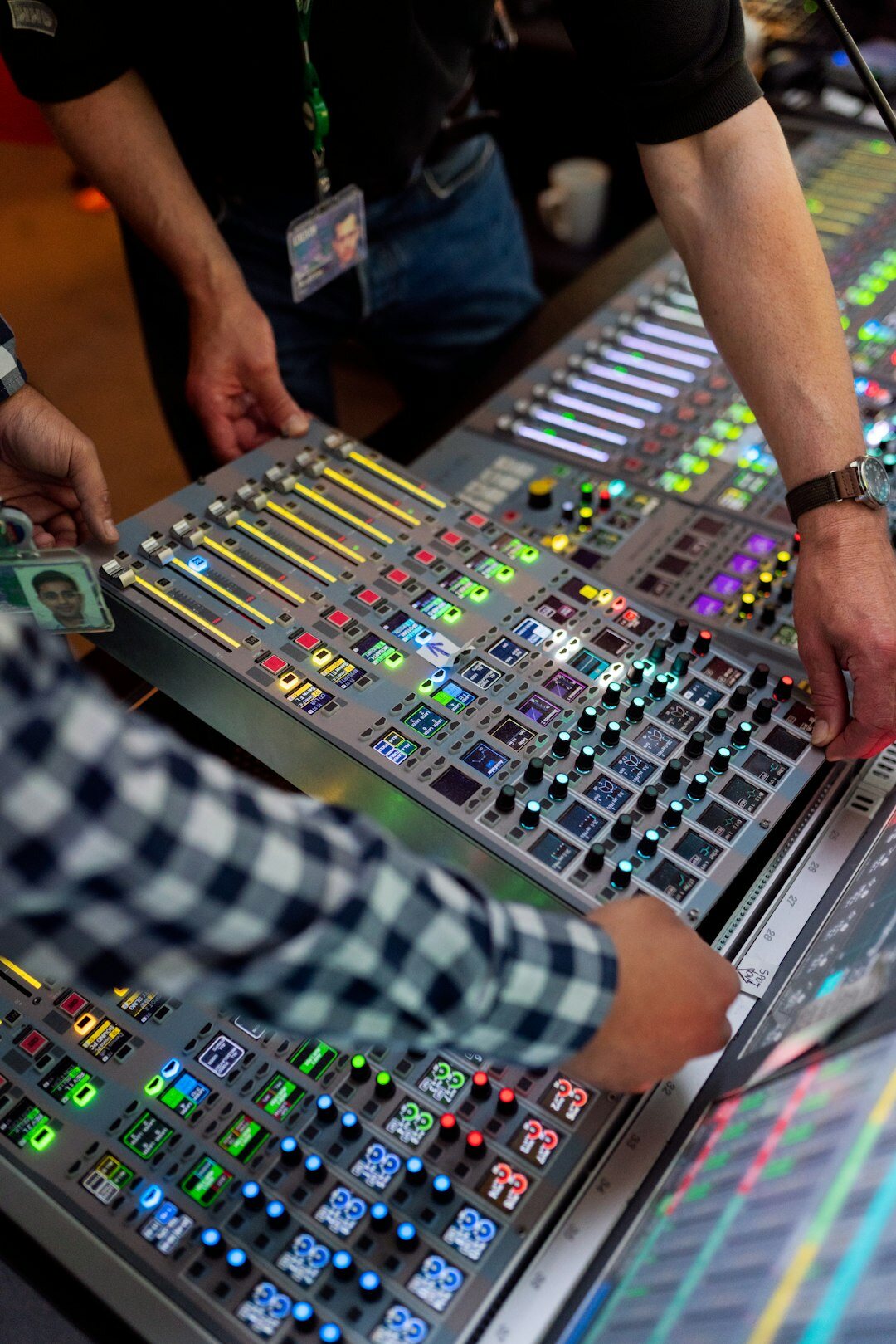 Sound engineer mixing audio at a broadcast studio sound console