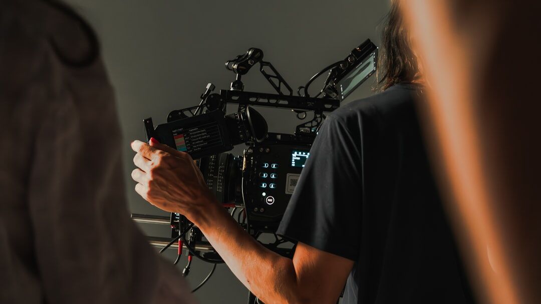 Camera operator filming a live television news segment in a studio