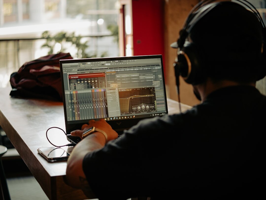 Video editor working on post-production workflow at editing workstation